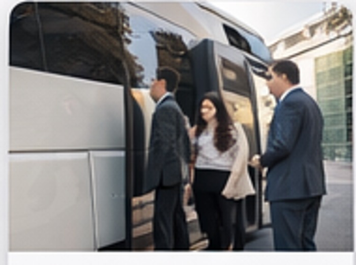 Passengers boarding a charter bus for corporate transportation