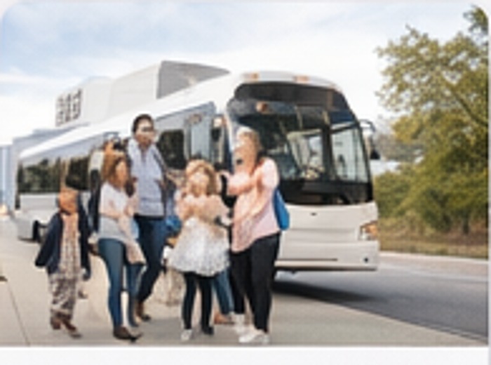 Students and families near a charter bus for school and field trips